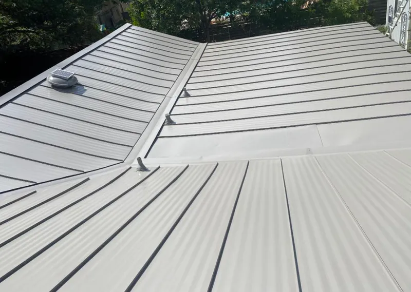 Solar attic fan installed on a metal roof for Roof Ventilation in Flower Mound